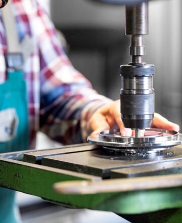 CNC drilling of a metal component for pulley or housing in industrial manufacturing